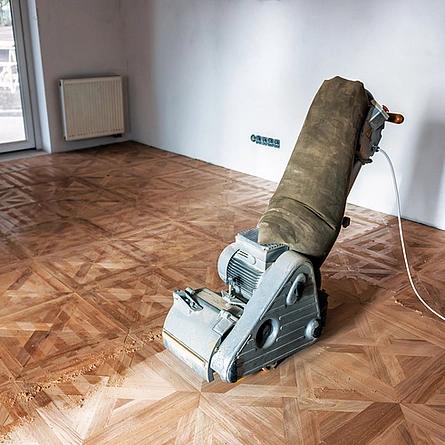 Schleifen von Parkett, Tafelboden mit der Schleifmaschine. - Schleifen von Parkett, Tafelboden mit der Schleifmaschine.